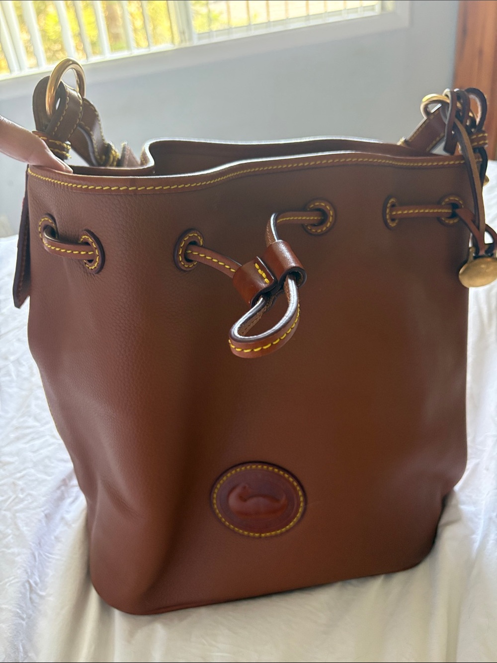 Dooney & Bourke Brown Leather Drawstring Bucket Bag with Yellow Stitching